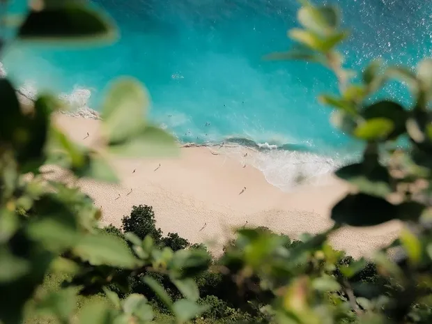 A beach in side a cave at Uluwatu. I remember the sand was not powdery there, it felt like walking on broken glass.
